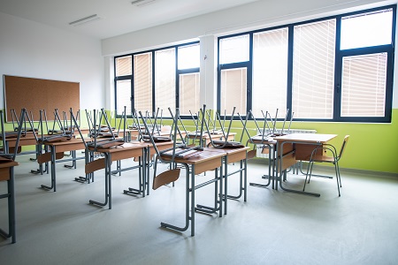 School classroom with chairs on the desks.